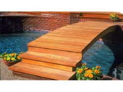 Here is a beautiful redwood 10 foot plank step bridge over a Awesome pool setting.