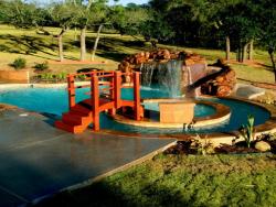 Here we have a very nice pool with a step bridge to access the hot tub. Located in TX