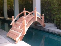 Here we have a very special high arch 12 footer with short post built at a 45 degree angle to provide clearance to walk out of the house and to be able to use the lap pool.Located in Manhattan Beach,CA.